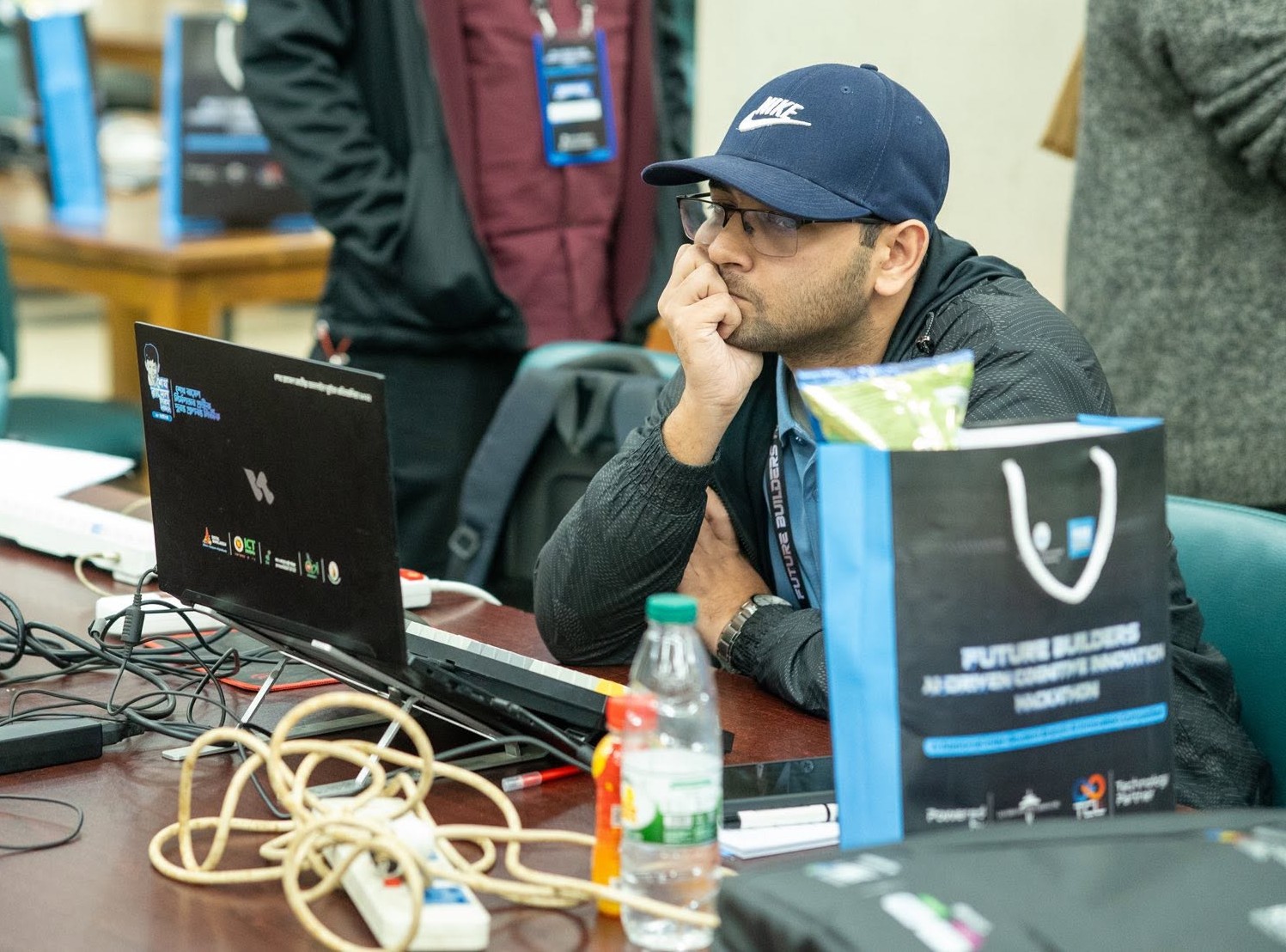A picture of me looking at my laptop during a hackathon